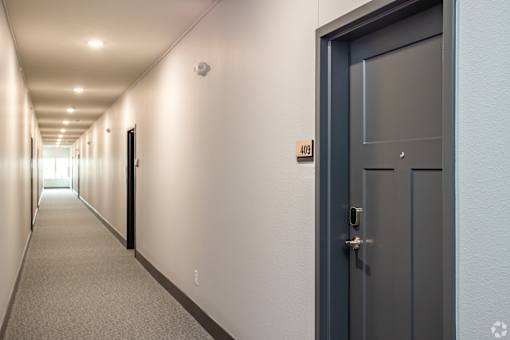A long hallway with a door on the right.