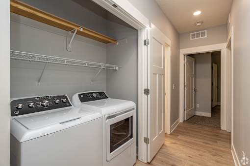 A white oven and stove top are in a small kitchen.