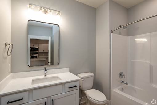 A bathroom with a sink, toilet, and bathtub.