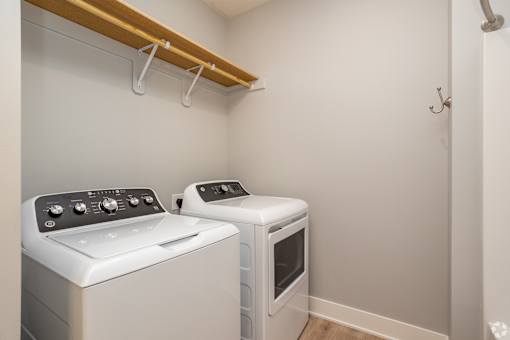 A small laundry room with a washer and dryer.