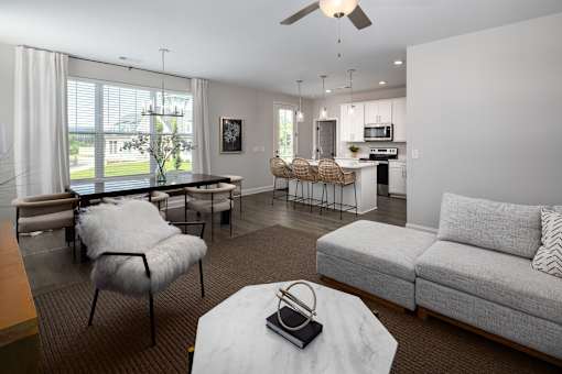 A living room with a grey couch and a white coffee table.