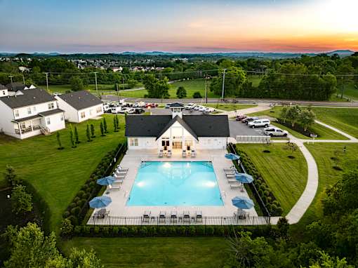 A large house with a pool in the backyard.