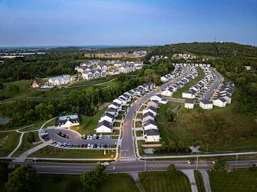 A residential area with houses and a road.