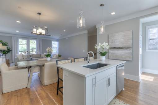 A kitchen with a dining table and chairs.