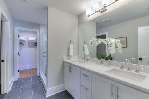 A bathroom with two sinks and a large mirror.