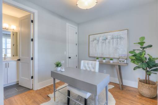 A dining room with a table and chairs.
