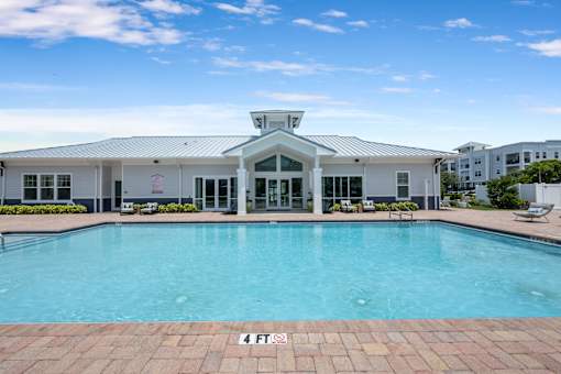 A large swimming pool in front of a building.