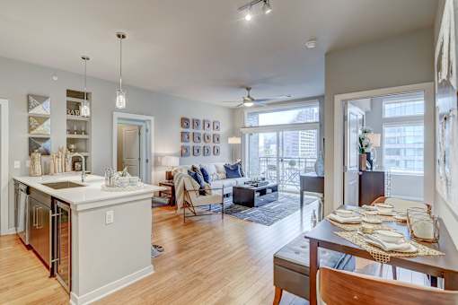 A modern kitchen with a dining table and chairs.