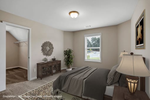 an image of a bedroom with a bed and a closet