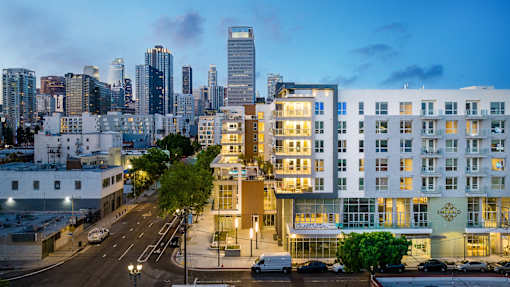 A cityscape with a hotel in the foreground and a skyline in the background.