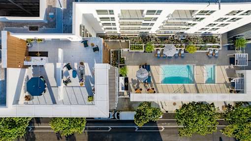 A top-down view of a modern outdoor seating area with a pool.
