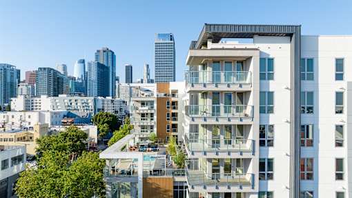 A cityscape with modern buildings and a clear blue sky.