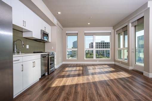 A kitchen with white cabinets and stainless steel appliances.
