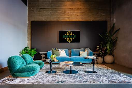 A living room with a green chair and a blue couch.