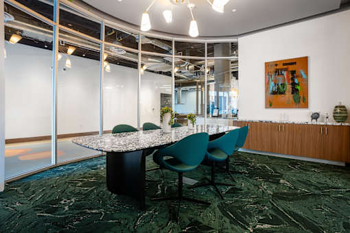 A conference room with a table and chairs.