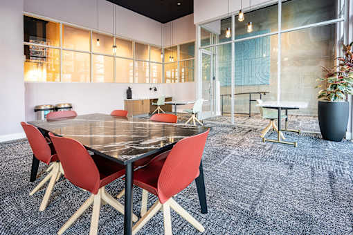 A modern dining room with a large table and chairs.