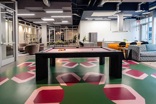A modern office space with a long table and chairs.