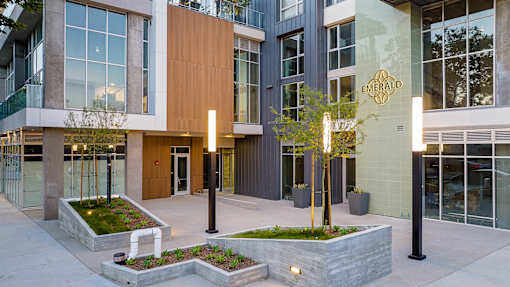 A modern building with a green lawn in front.