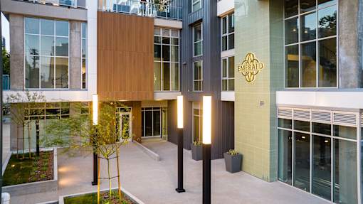 A modern building with a green sign that says Emerald.
