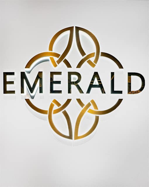 The image features the word "EMERALD" in gold letters with a circular design beneath it.