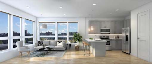 A modern kitchen with a dining table and chairs is adjacent to a living room with a couch and a coffee table.