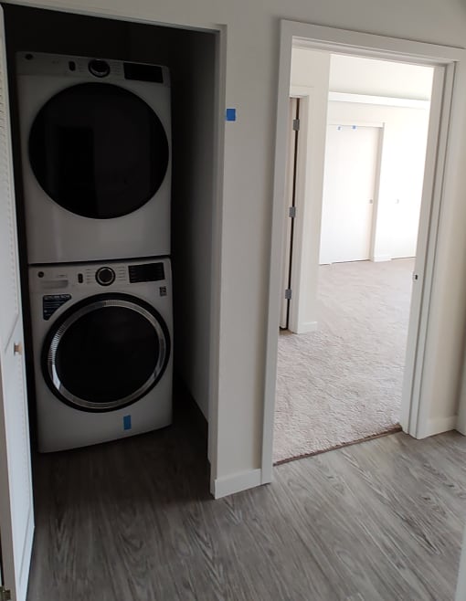 a front loading washer and dryer in a laundry room