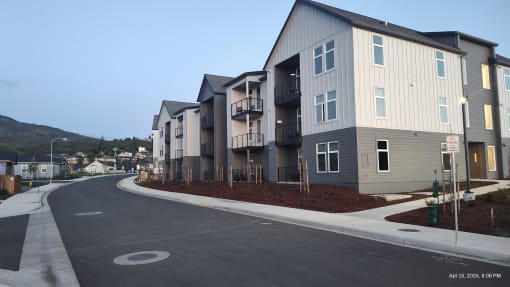 an empty street in front of an apartment building