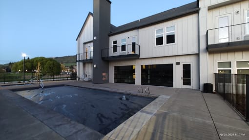 a new house with a swimming pool in front of it