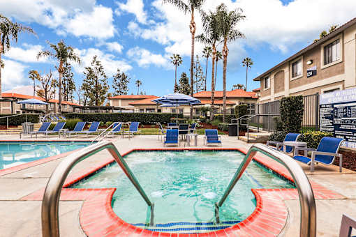 A pool and jacuzzi with a red and green design in the middle of it.