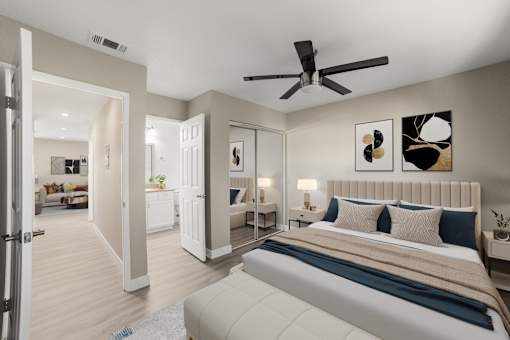 A bedroom with a large bed and a ceiling fan.