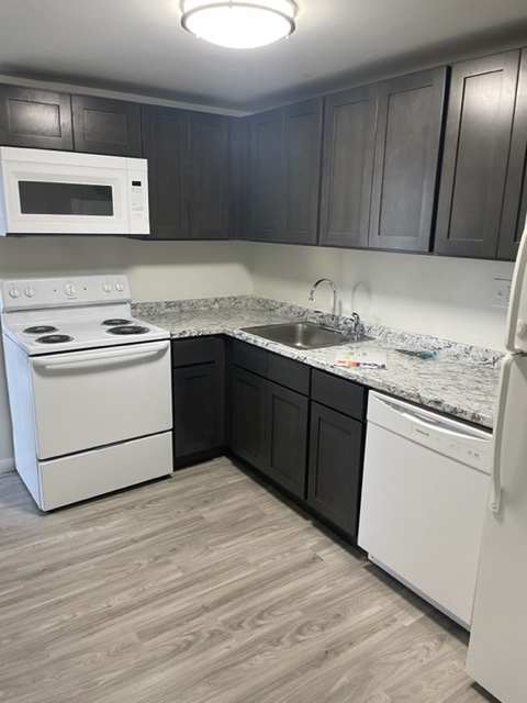 a laundry room with a washer and dryer in a kitchen