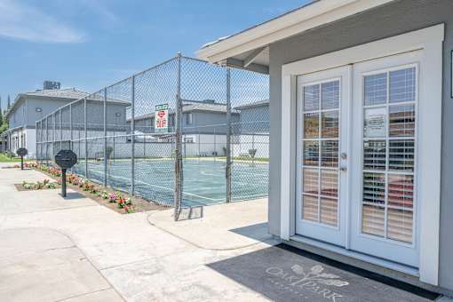 a house with a tennis court in front of it