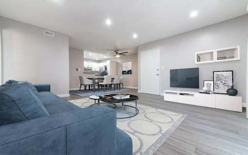 a living room filled with furniture and a flat screen tv