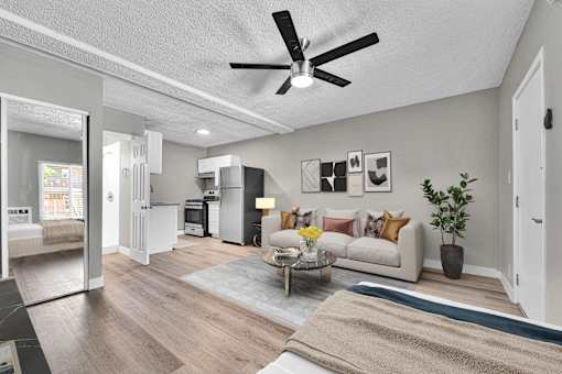 A living room with a white couch and a coffee table.