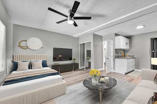 A modern bedroom with a large bed and a ceiling fan.