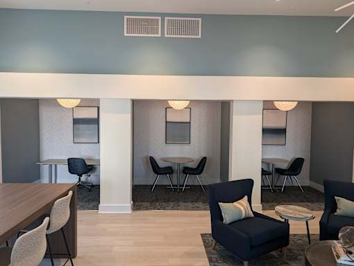 A room with a table, chairs and a couch.