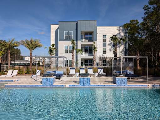 A modern building with a pool in front.