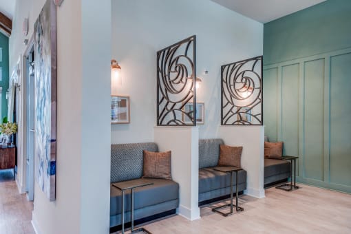a living room with two couches and a hallway with a door