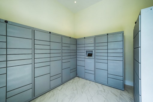 a large storage room with large metal lockers and a refrigerator