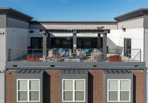 the upper deck of a building with tables and chairs