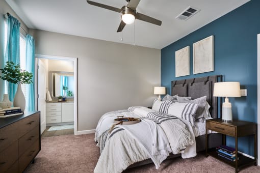 a bedroom with a large bed and a ceiling fan