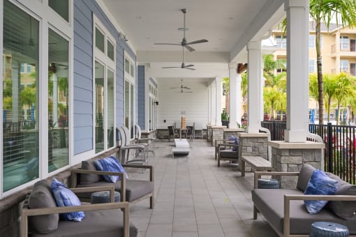 a porch with couches and chairs on a patio