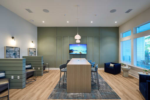 a conference room with a table and chairs and a television