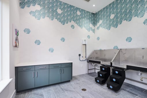 a kitchen with a large sink and a counter with two refrigerators