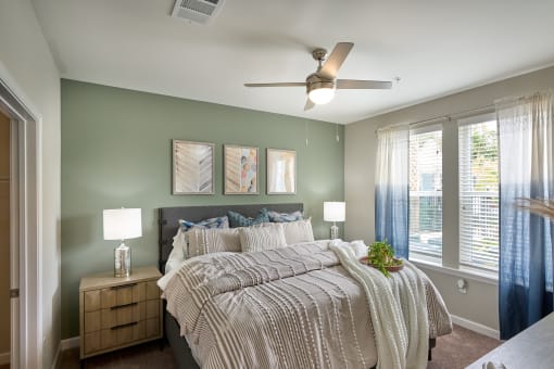 a bedroom with a large bed and a ceiling fan