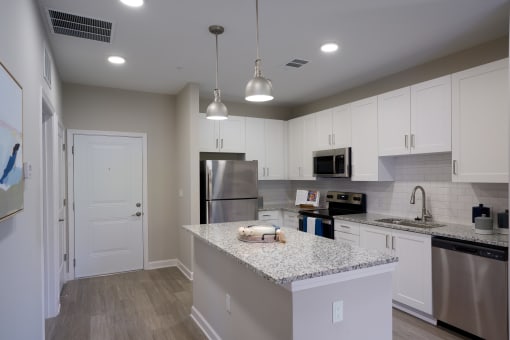 a kitchen with granite counter tops and stainless steel appliances