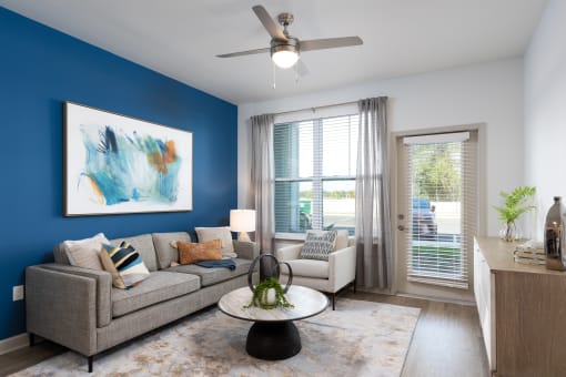 a living room with a blue accent wall and a couch