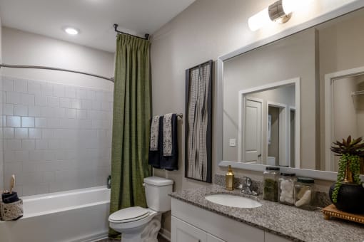 a bathroom with a shower and a toilet and a sink