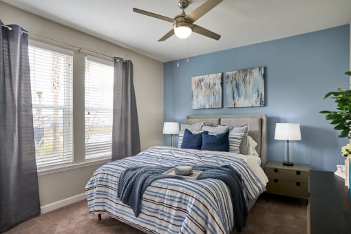 a bedroom with a large bed and a ceiling fan