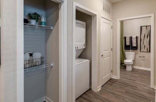 a bathroom with a closet and a toilet and a sink